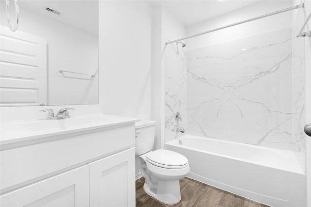 full bathroom with tiled shower / bath combo, wood-type flooring, vanity, and toilet