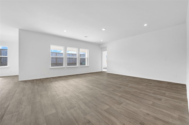 unfurnished room with wood-type flooring