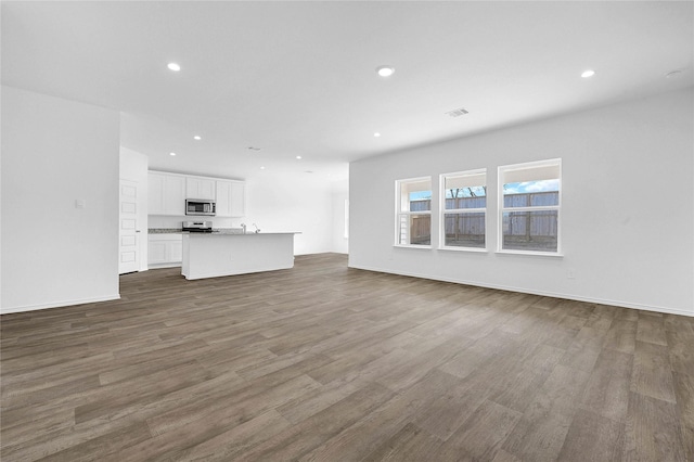 unfurnished living room with dark hardwood / wood-style floors