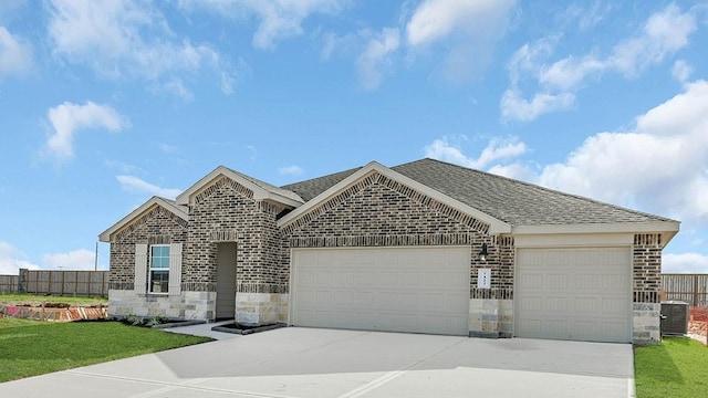 view of front of property featuring a garage and central air condition unit