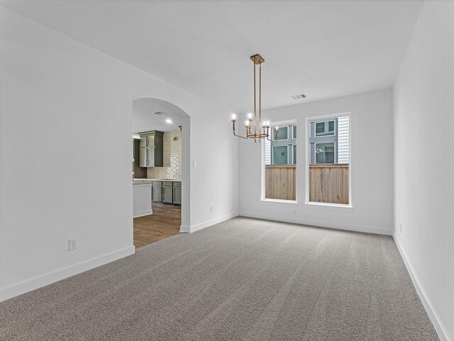 8318 Aussie Beadhead Dr, Fulshear, TX 77441 - carpeted empty room with a chandelier and arched walkways