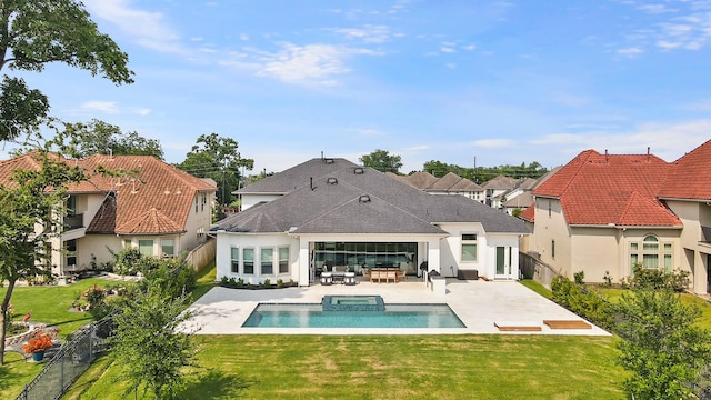 back of house featuring a yard, a patio area, and a pool with hot tub