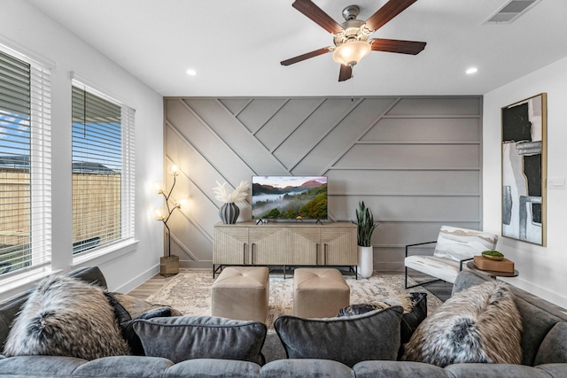 living room with ceiling fan and light hardwood / wood-style floors