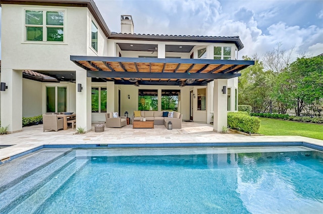 back of property featuring a patio, ceiling fan, a chimney, an outdoor hangout area, and stucco siding