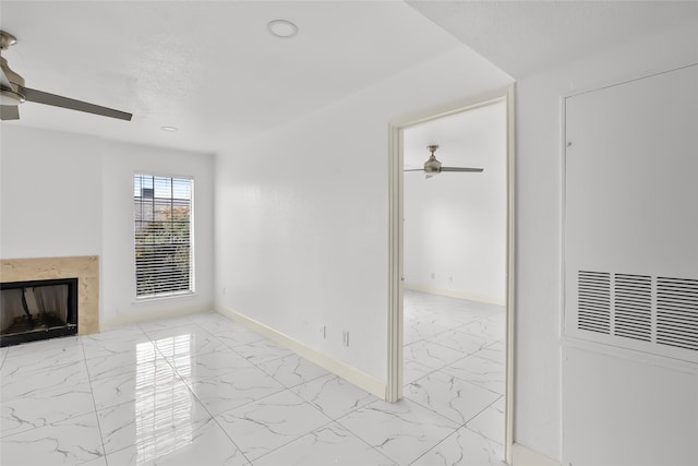 unfurnished living room featuring ceiling fan