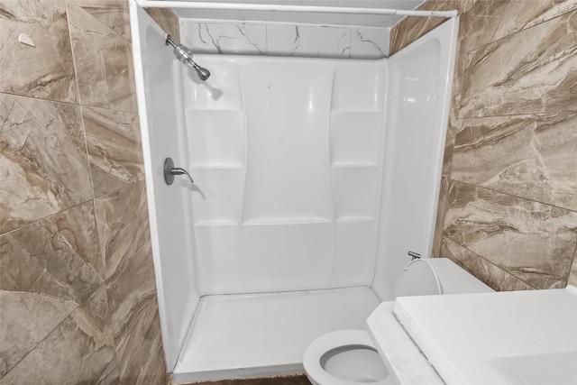 bathroom with walk in shower and toilet