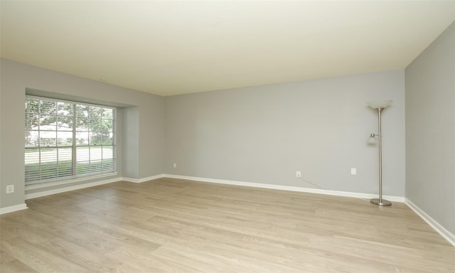 unfurnished room with light wood-type flooring