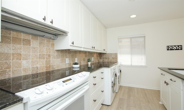 clothes washing area featuring separate washer and dryer and light hardwood / wood-style floors