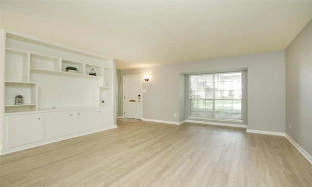 unfurnished room with light wood-type flooring