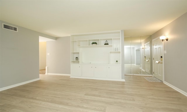 unfurnished living room with light hardwood / wood-style flooring