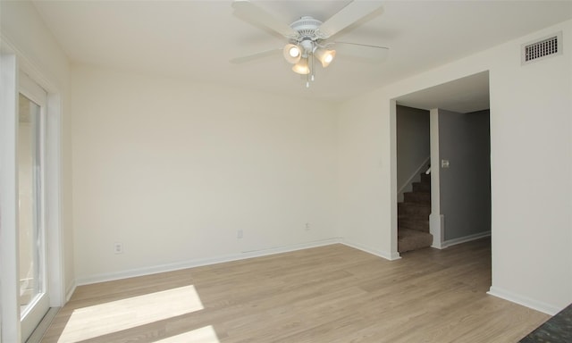 unfurnished room with ceiling fan and light wood-type flooring