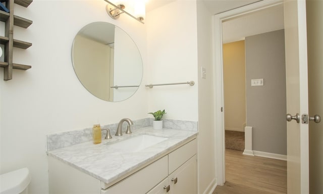 bathroom featuring hardwood / wood-style flooring, vanity, and toilet