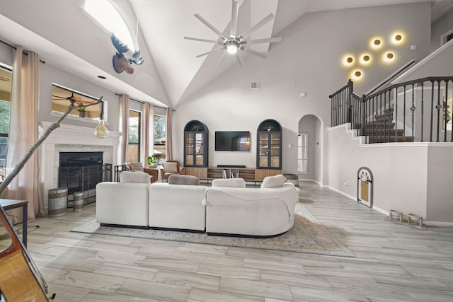 living room featuring high vaulted ceiling and ceiling fan