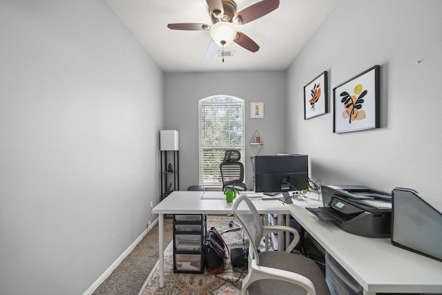 carpeted office featuring ceiling fan