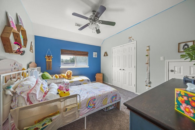 carpeted bedroom with lofted ceiling, ceiling fan, and a closet