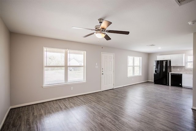 unfurnished living room featuring dark wood-type flooring, ceiling fan, and a healthy amount of sunlight