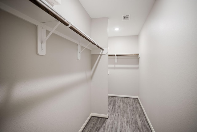 walk in closet featuring hardwood / wood-style flooring