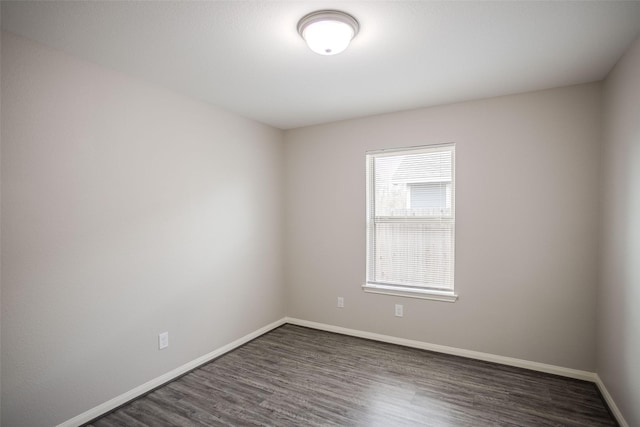 spare room with dark hardwood / wood-style flooring