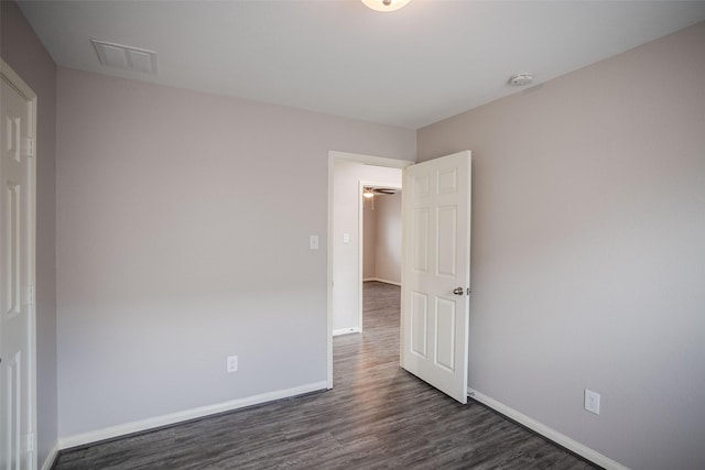 spare room with dark hardwood / wood-style flooring