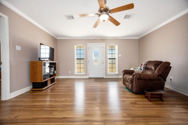 living area with crown molding, hardwood / wood-style floors, and ceiling fan