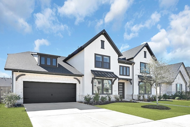 view of front of property with a garage and a front lawn