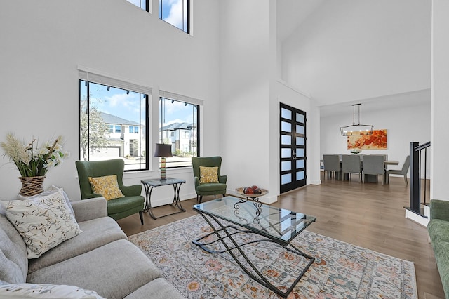 living room featuring wood-type flooring and a notable chandelier