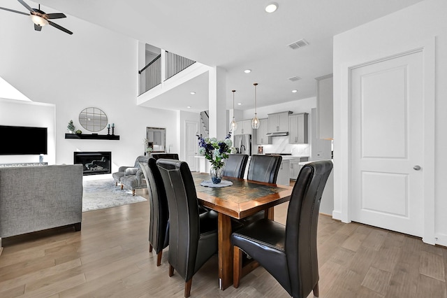 dining room with ceiling fan and light wood-type flooring