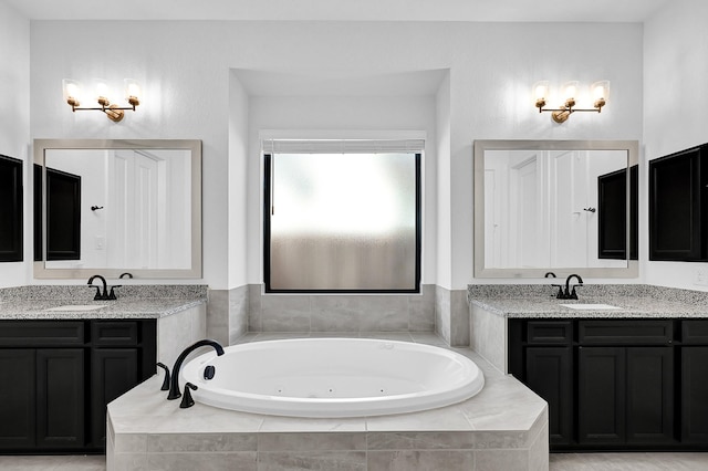 bathroom with a relaxing tiled tub and vanity