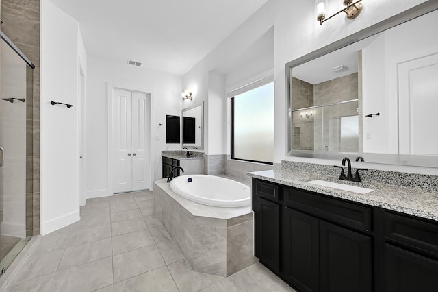 bathroom featuring tile patterned flooring, vanity, and separate shower and tub