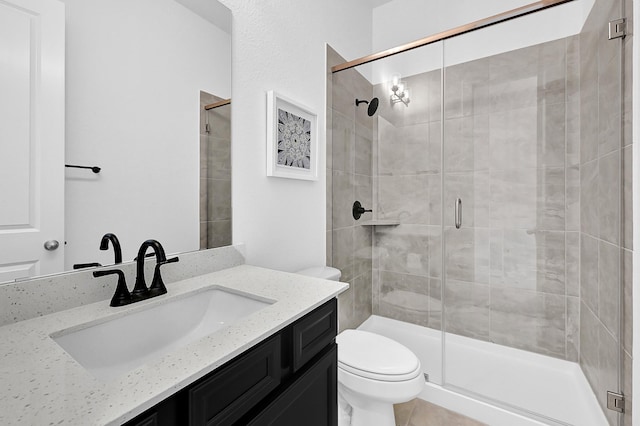 bathroom featuring vanity, walk in shower, and toilet