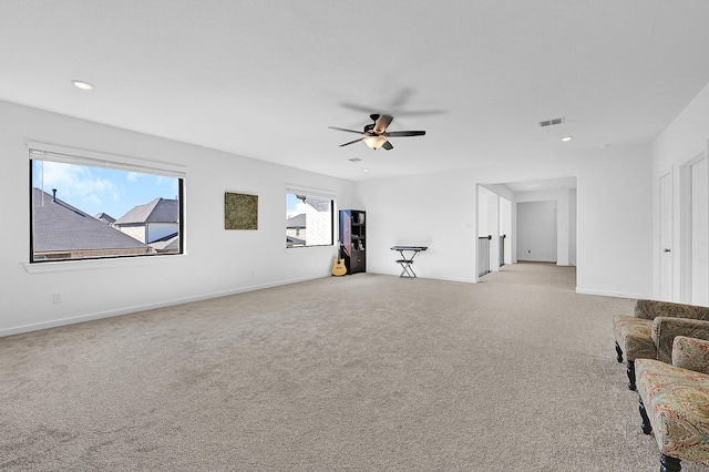 living room featuring light carpet and ceiling fan