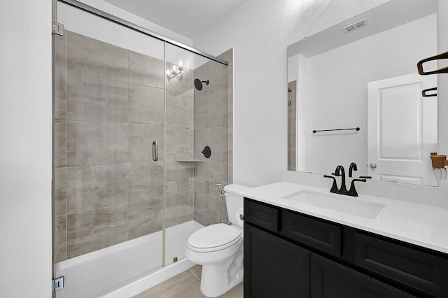 bathroom featuring vanity, toilet, and walk in shower