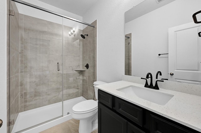 bathroom with vanity, toilet, and an enclosed shower