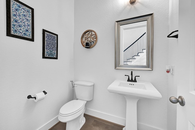 bathroom with wood-type flooring and toilet