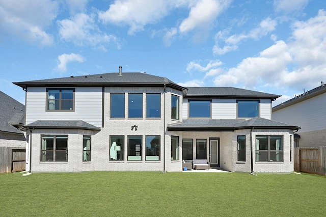 back of house featuring a yard and a patio