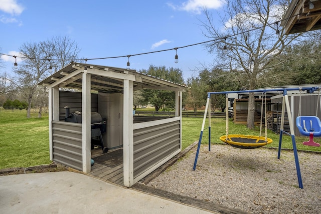 view of outdoor structure featuring a playground and a yard