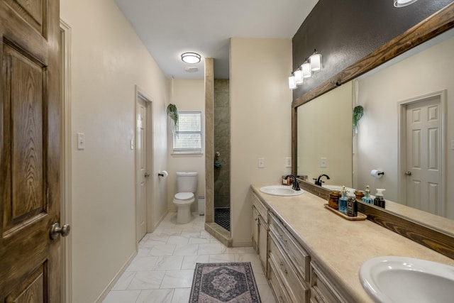 bathroom with vanity, a tile shower, and toilet