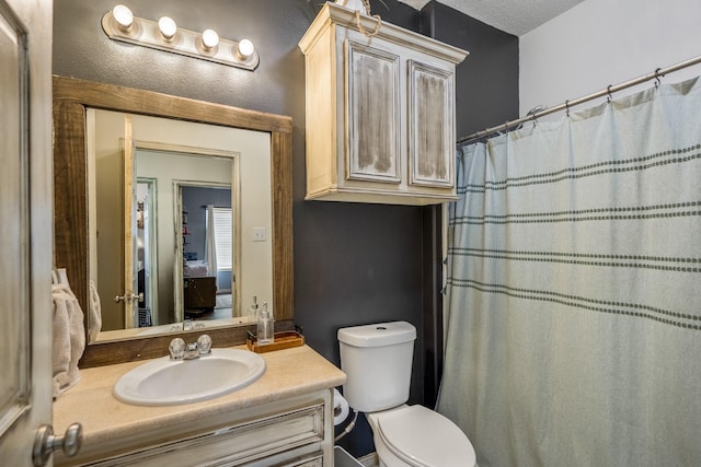 bathroom with vanity, toilet, and a shower with shower curtain