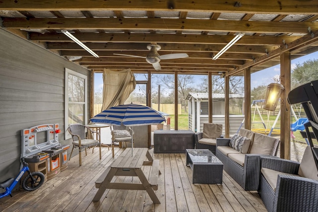 sunroom / solarium featuring ceiling fan