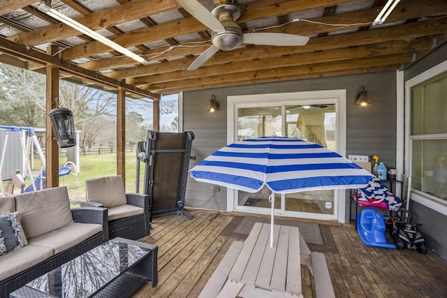 sunroom featuring ceiling fan