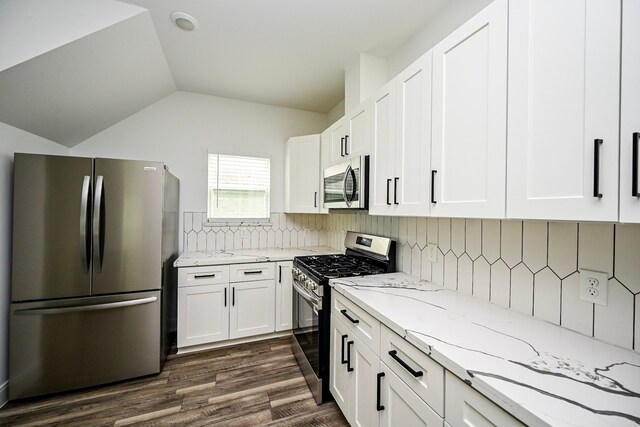 1415 E 35th St, Houston, TX 77022 - kitchen with stainless steel appliances, light stone counters, white cabinets, dark wood-style floors, and lofted ceiling