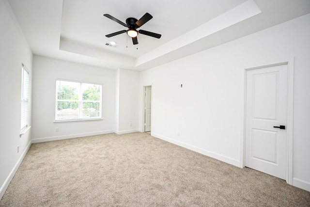 1415 E 35th St, Houston, TX 77022 - spare room with a tray ceiling, carpet flooring, and a ceiling fan