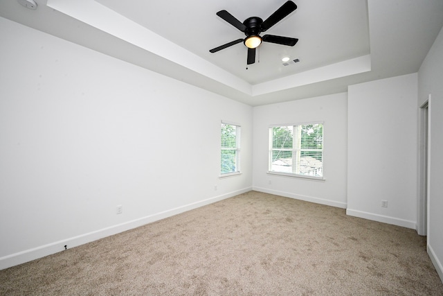 1415 E 35th St, Houston, TX 77022 - empty room with a tray ceiling, carpet flooring, and ceiling fan