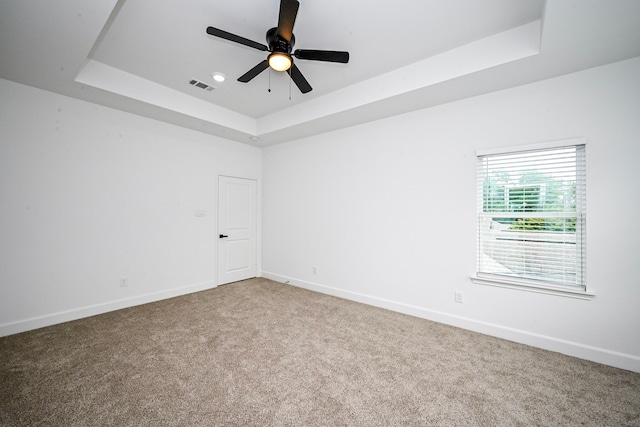 1415 E 35th St, Houston, TX 77022 - spare room with a tray ceiling, carpet floors, and ceiling fan
