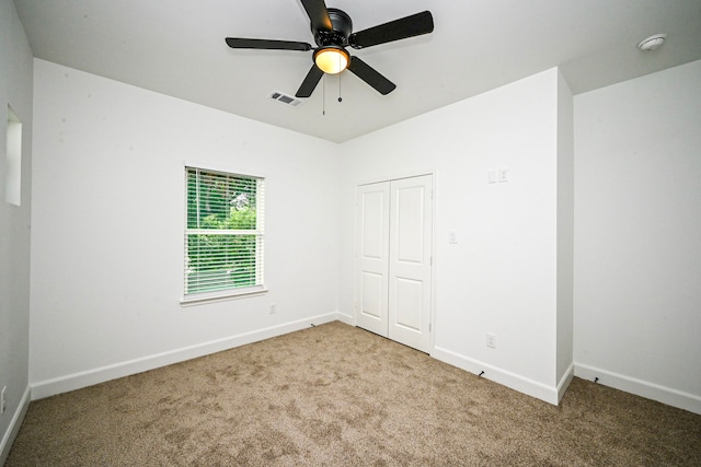 1415 E 35th St, Houston, TX 77022 - unfurnished bedroom with carpet flooring, a closet, and a ceiling fan