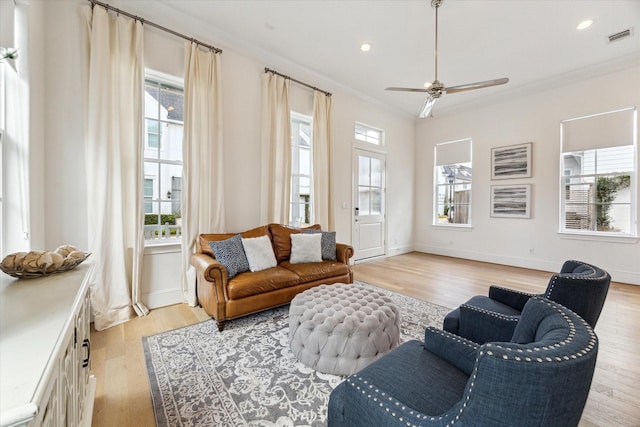 sitting room with ornamental molding, a wealth of natural light, and visible vents