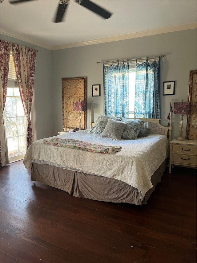 bedroom featuring ornamental molding, ceiling fan, and dark hardwood / wood-style flooring