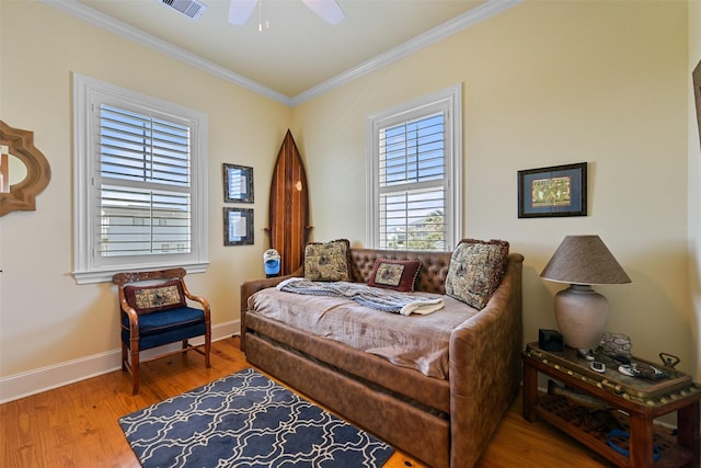 bedroom featuring crown molding, ceiling fan, and wood-type flooring