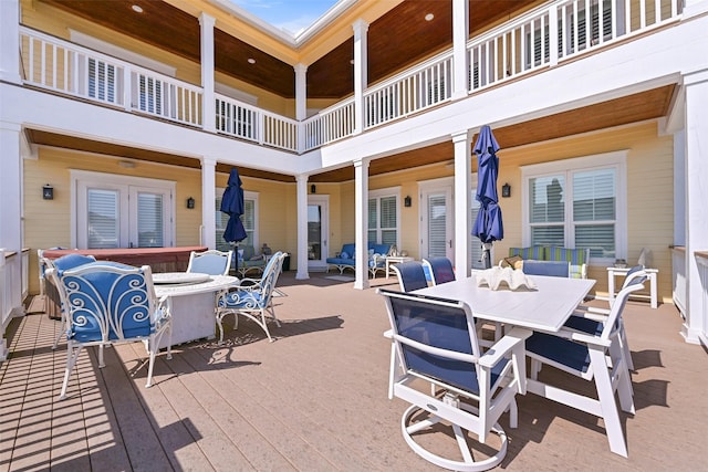 view of patio featuring a deck and a hot tub