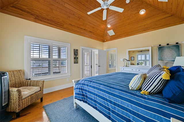 bedroom featuring multiple windows, lofted ceiling, light hardwood / wood-style floors, and wood ceiling